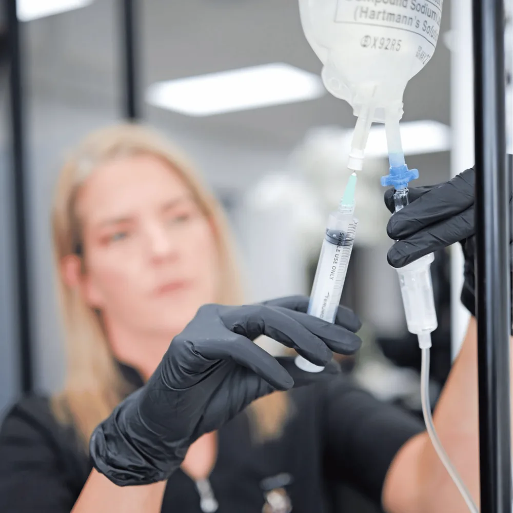 A Nandish Health nurse preparing an IV infusion